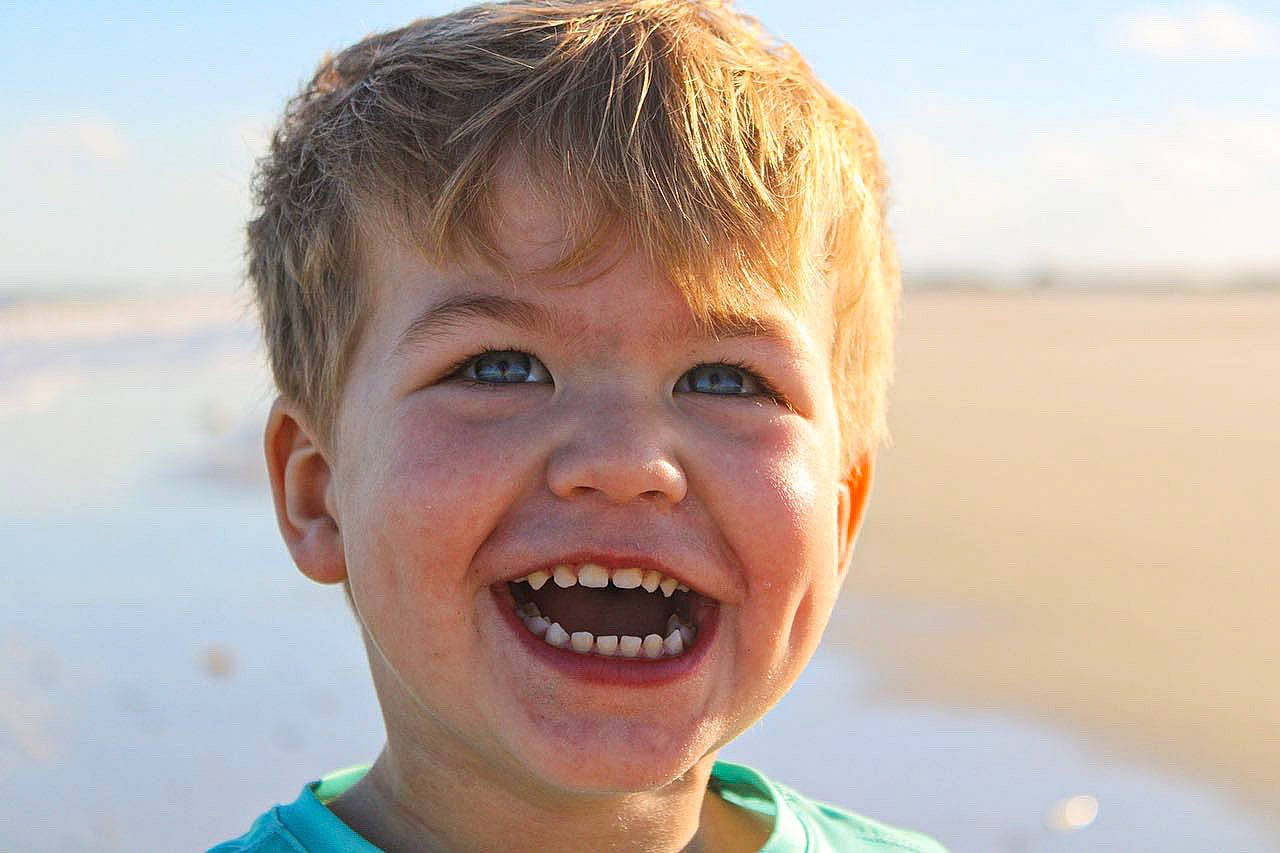 Brantley is registered to the contest to win money with this photo: body_of_water, flash_photography, fun, happy, human_body, iris, jaw, joy, lip, mouth, neck, nose, people_in_nature, person, skin, sky, smile, sunlight, toddler, tooth