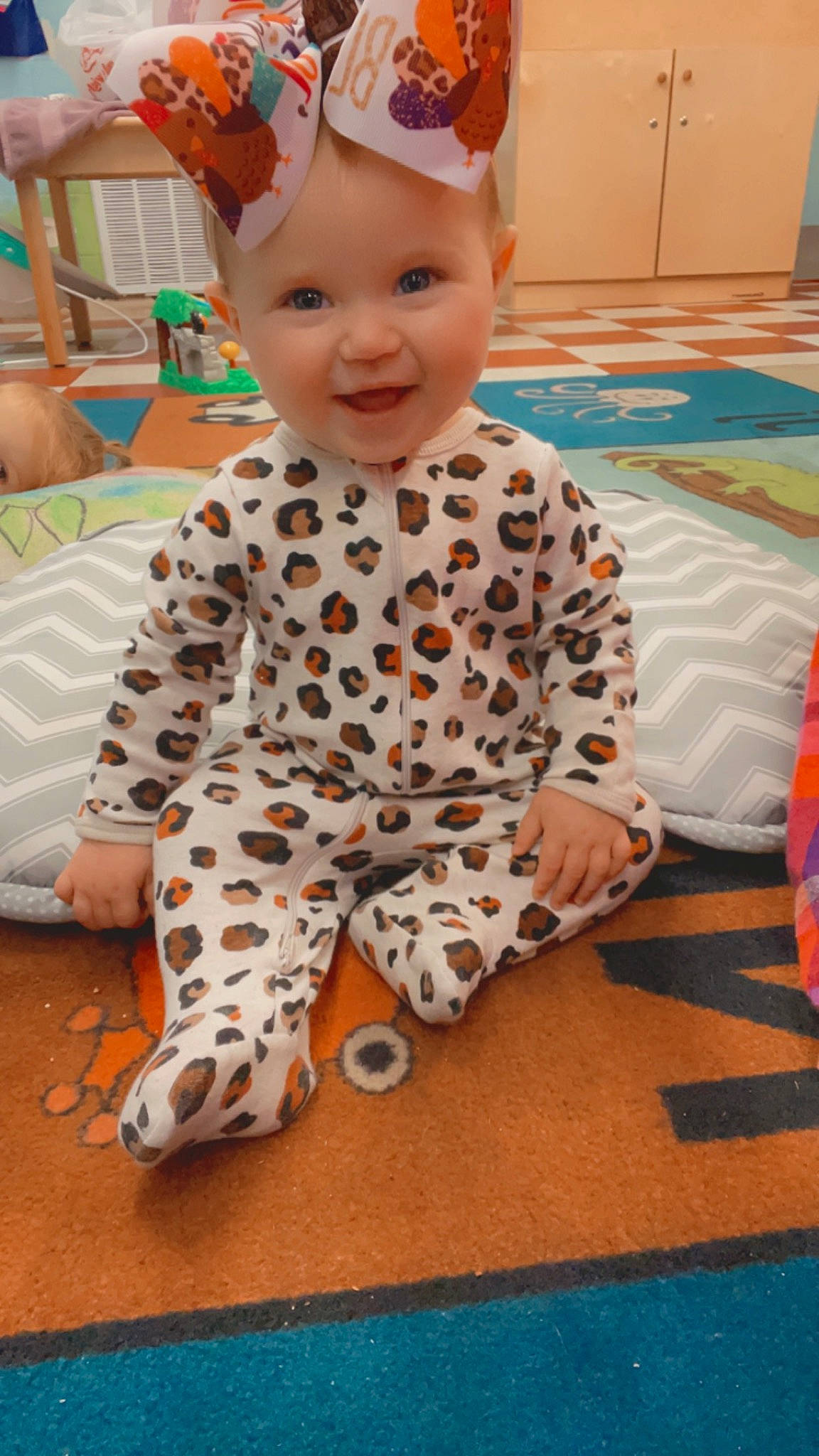 Charleigh is registered to the contest to win money with this photo: baby, baby_toddler_clothing, carmine, carpet, child, costume, costume_hat, floor, flooring, fun, happy, headwear, joy, party_supply, pattern, person, play, room, sitting, sleeve