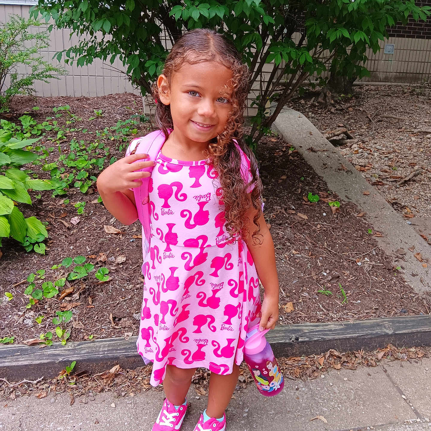 Xiomara joined the competition — help win amazing prizes! backyard, child, clothing, dress, face, footwear, head, herbal, herbs, nature, outdoors, path, person, photography, plant, portrait, sandal, shoe, walkway, yard