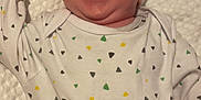 Ezra joined the competition — help win amazing prizes! baby, infant, smiling, laughing, onesie, hat, hand, tickling, blanket, white, cute, joyful, happy, skin, human, person, lying_down, indoors, closeup, face