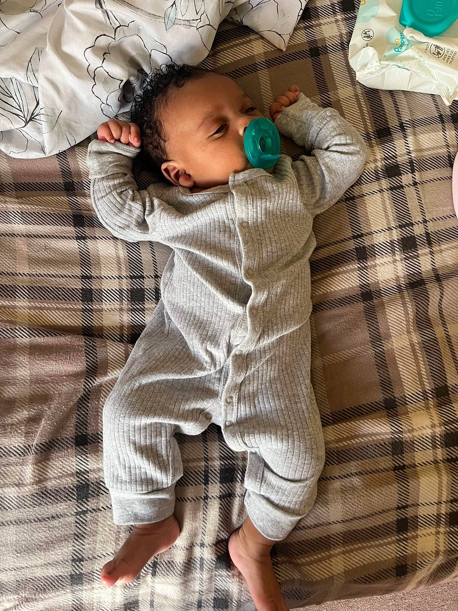 Jaiden is registered to the contest to win money with this photo: baby, baby_sleeping, baby_toddler_clothing, bedding, child, comfort, eye, foot, happy, human_leg, linens, pattern, person, plaid, skin, sleeve, t_shirt, textile, thigh, toddler
