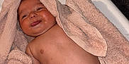 Islem participe au concours pour gagner de l'argent avec cette photo : baby, blanket, body, changing_pad, cheeky, child, cute, face, happy, head, indoor, infant, lying_down, newborn, peach, skin, smiling, soft_texture, tongue_out, towel