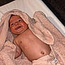 baby, blanket, body, changing_pad, cheeky, child, cute, face, happy, head, indoor, infant, lying_down, newborn, peach, skin, smiling, soft_texture, tongue_out, towel