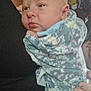 Ashlynn Dann joined the competition — help win amazing prizes! baby, infant, person, blanket, floral_pattern, holding, close_up, face, skin, hand, comfort, cuddle, indoor, adult, clothing, portrait, expression, resting, warm, soft