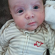 Kasen joined the competition — help win amazing prizes! baby, infant, newborn, onesie, striped_clothing, heart_logo, blanket, couch, closeup, face, eyes, cheeks, skin, hair, zipper, portrait, lying_down, cozy, soft_texture, expression