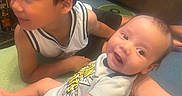 Justin joined the competition — help win amazing prizes! baby, carpet, child, clothing, couch, face, furniture, game_controller, hair, happy, indoor, living_room, person, playing, shirt, shorts, sitting, skin, smile, toddler