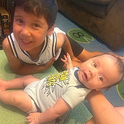 Justin joined the competition — help win amazing prizes! baby, toddler, child, smiling, carpet, couch, indoor, happy, clothing, person, face, floor, sitting, arm, hand, home, family, cute, infant, play