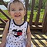 Ensley joined the competition — help win amazing prizes! child, toddler, smiling, headband, bow, dress, stars, outdoor, sunny, wooden_deck, grass, lake, happy, person, summer, nature, fashion, portrait, baby, cute