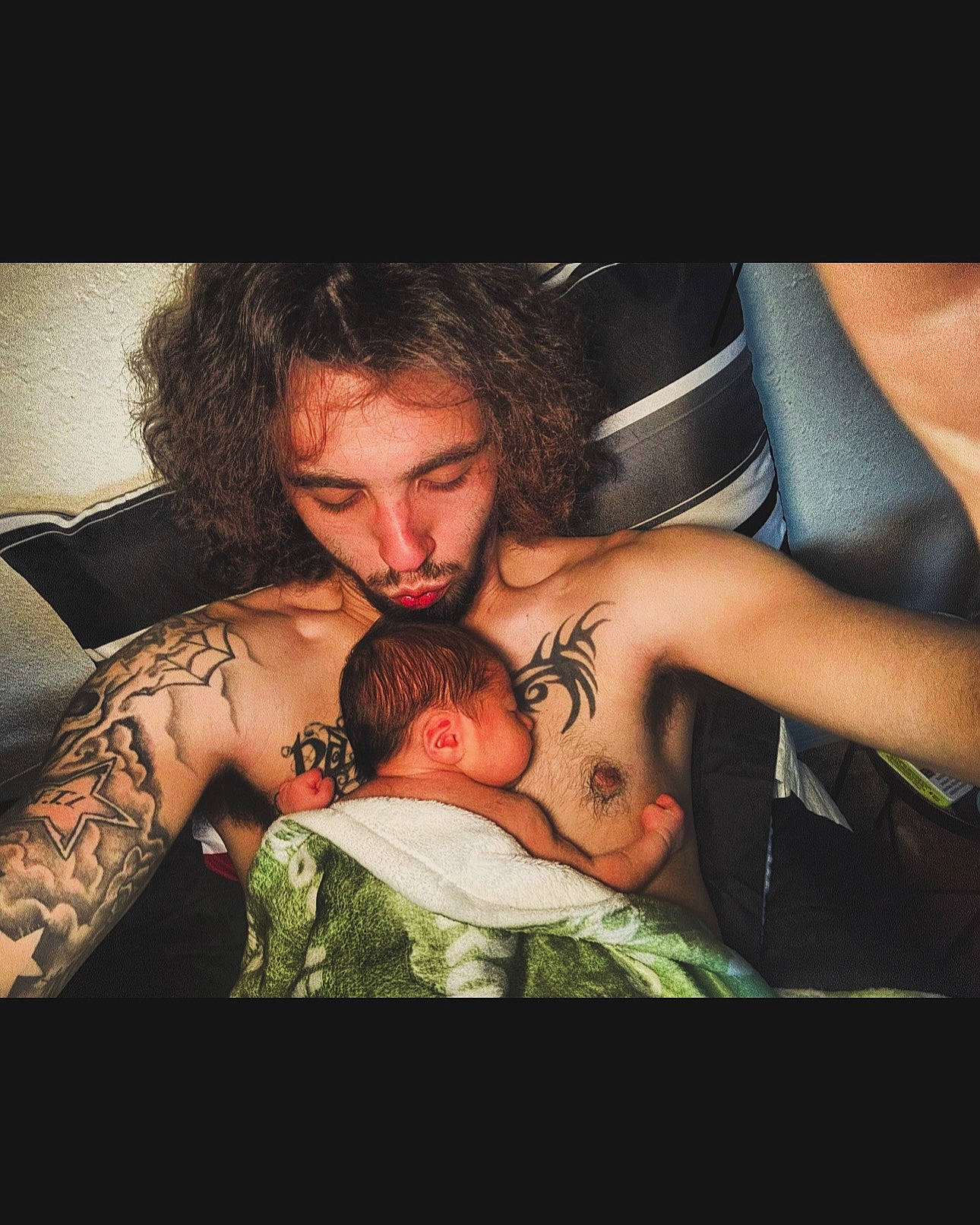 Rosalia is registered to the contest to win money with this photo: abdomen, baby, barechested, beard, chest, elbow, event, facial_hair, flash_photography, flesh, gesture, happy, human_body, muscle, person, romance, tattoo, temporary_tattoo, thigh, trunk