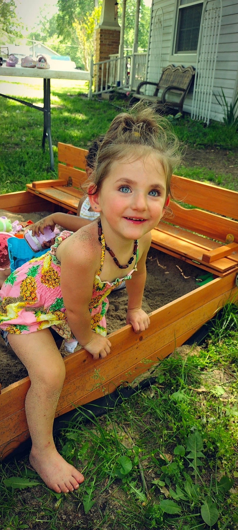 Ella-mae is registered to the contest to win money with this photo: chair, child, dress, fun, grass, hair, hairstyle, happy, human_leg, joy, leisure, people_in_nature, person, plant, play, recreation, skin, smile, thigh, toddler
