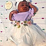 Neriah is registered to the contest to win money with this photo: baby, sleeping, infant, purple_clothing, white_skirt, embroidered_flowers, headband, milestone_plaque, blanket, patterned_blanket, tulle, socks, cute, peaceful, portrait, child, newborn, baby_girl, soft_lighting, indoor