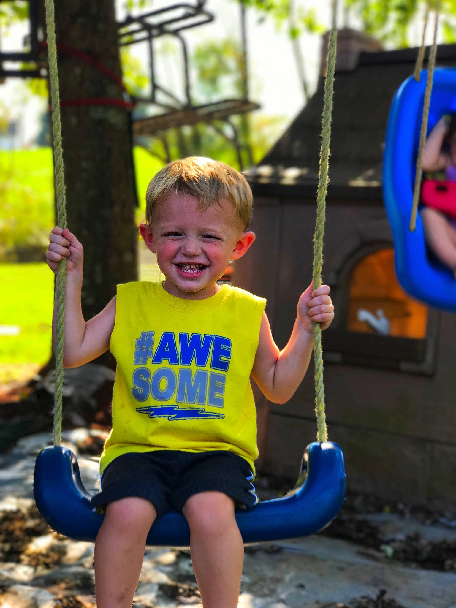 Coltan Newcomb is registered to the contest to win money with this photo: child, day, facial_expression, fun, girl, joy, leisure, outdoor_play_equipment, person, play, playground, public_space, recreation, smile, summer, swing, toddler, tree, vacation