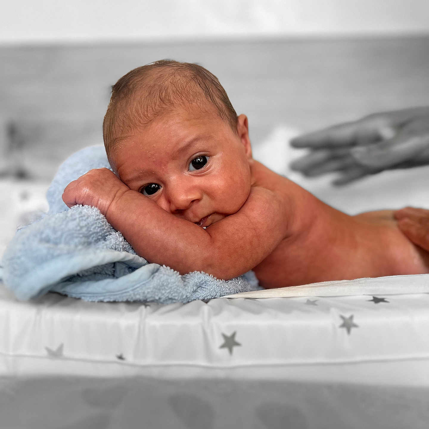 Devon joined the competition — help win amazing prizes! baby, bed, blanket, closeup, curious, cute, expression, eyes, face, hand, human, indoors, infant, lying_down, newborn, portrait, resting, skin, soft_texture, towel