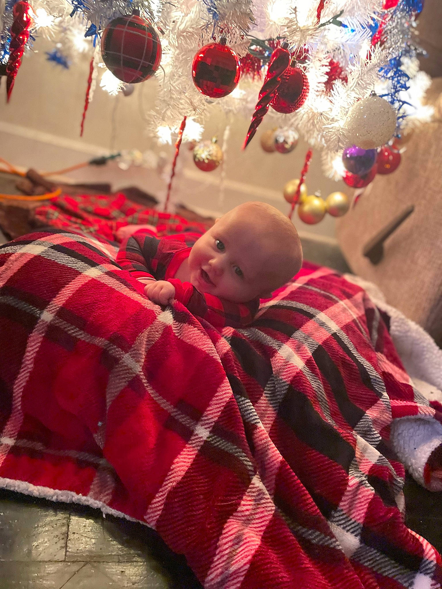Emmett is registered to the contest to win money with this photo: baby, christmas_decoration, christmas_ornament, comfort, decoration, event, happy, holiday, holiday_ornament, light, ornament, party_supply, pattern, person, photograph, plaid, red, snapshot, tartan, textile