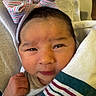 Adira is registered to the contest to win money with this photo: baby, newborn, infant, face, headband, bow, blanket, striped, clothing, fist, closeup, cute, sleepy, skin, person, portrait, young, child, indoors, soft