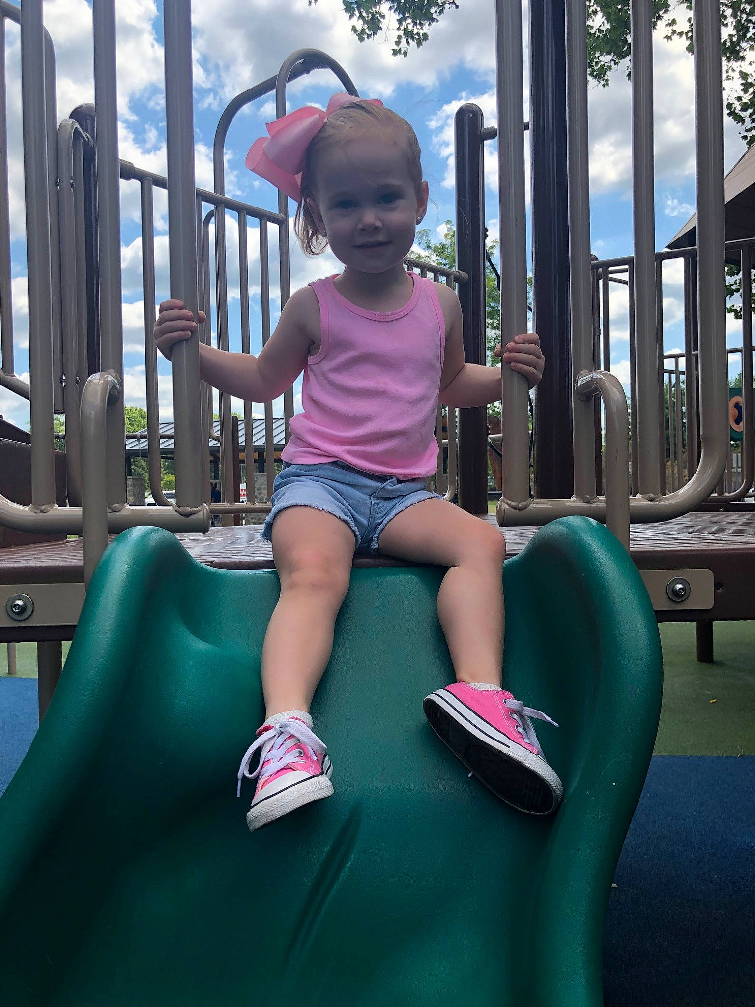 Selah joined the competition — help win amazing prizes! child, city, fun, human_settlement, leisure, outdoor_play_equipment, person, physical_fitness, pink, play, playground, playground_slide, public_space, recreation, sitting, smile, toddler, vacation