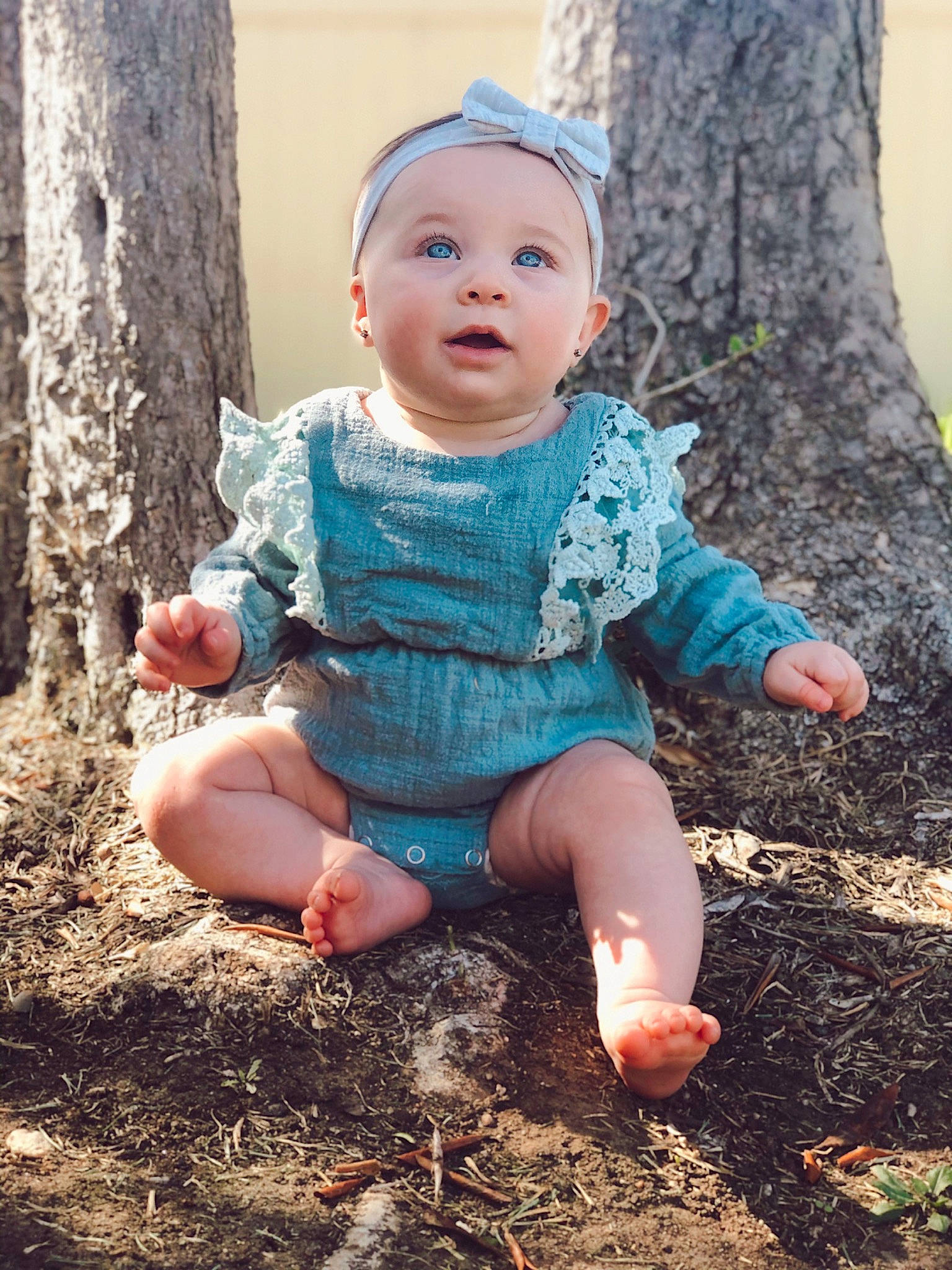 Willow is registered to the contest to win money with this photo: baby, cheek, child, eye, face, green, hand, head, leaf, leg, people, person, photograph, pink, plant, sitting, skin, smile, soil, toddler