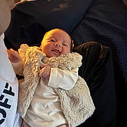 Milana-Maria is registered to the contest to win money with this photo: baby, child, clothing, cozy, cuddle, cute, fabric, face, hand, happy, indoor, infant, light, newborn, person, portrait, smile, soft, vest, warm