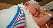 Colton is registered to the contest to win money with this photo: adult, baby, blanket, cap, child, closeup, comfort, cute, hospital, hospital_bed, infant, medical, newborn, resting, skin, sleeping, swaddled, tattoo, tender_moment, wristband