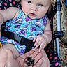 animal, baby, blue_eyes, child, clothing, curly_hair, cute, exploration, expression, frog, hand, leaves, nature, outdoor, person, sitting, skin, stroller, summer, tattoo