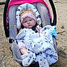 baby, baby_clothes, blanket, branches, bundle, car_seat, child, curly_hair, cute, expression, headband, infant, nature, outdoor, person, portrait, sand, seat, sitting, young