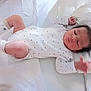 Adem participe au concours pour gagner de l'argent avec cette photo : baby, sleeping, infant, onesie, bed, pillow, white, soft, peaceful, newborn, hand, face, clothing, lying_down, cute, resting, indoors, child, skin, hair