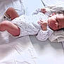adorable, baby, blanket, child, cute, human, indoors, infant, lying_down, newborn, onesie, peaceful, pillow, resting, sleeping, small, socks, soft, toddler, white
