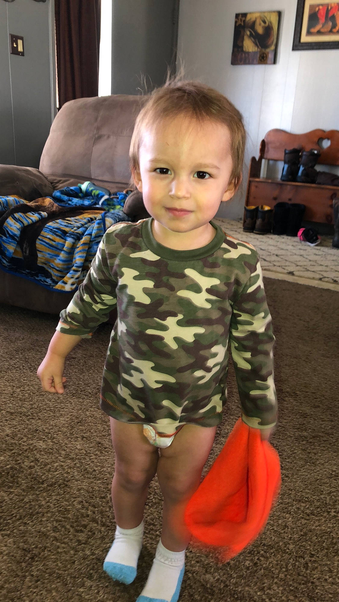 Ayden is registered to the contest to win money with this photo: baby, camouflage, child, design, head, leg, pattern, person, play, standing, toddler