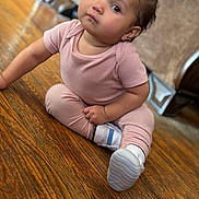 Eliani is registered to the contest to win money with this photo: baby, child, pink_outfit, sitting, wooden_floor, bow, curious_eyes, white_shoes, indoors, flooring, cute, portrait, home, furniture, person, small_child, infant, casual_clothing, looking_up, adorable