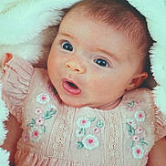 Alora joined the competition — help win amazing prizes! baby, blanket, child, closeup, cute, ear, embroidery, expression, eyes, face, floral_pattern, head, infant, mouth, newborn, person, pink_dress, portrait, skin, soft_texture