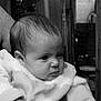 baby, infant, child, person, face, portrait, black_and_white, sweater, clothing, adult_hand, indoor, furniture, wood, expression, young, cute, closeup, skin, head, hair