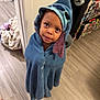bath_time, blanket, blue_towel, child, clothing, curious, cute, expression, face, floor, home, hooded_towel, indoor, person, standing, toddler, towel, wooden_floor, wrapped, young_child