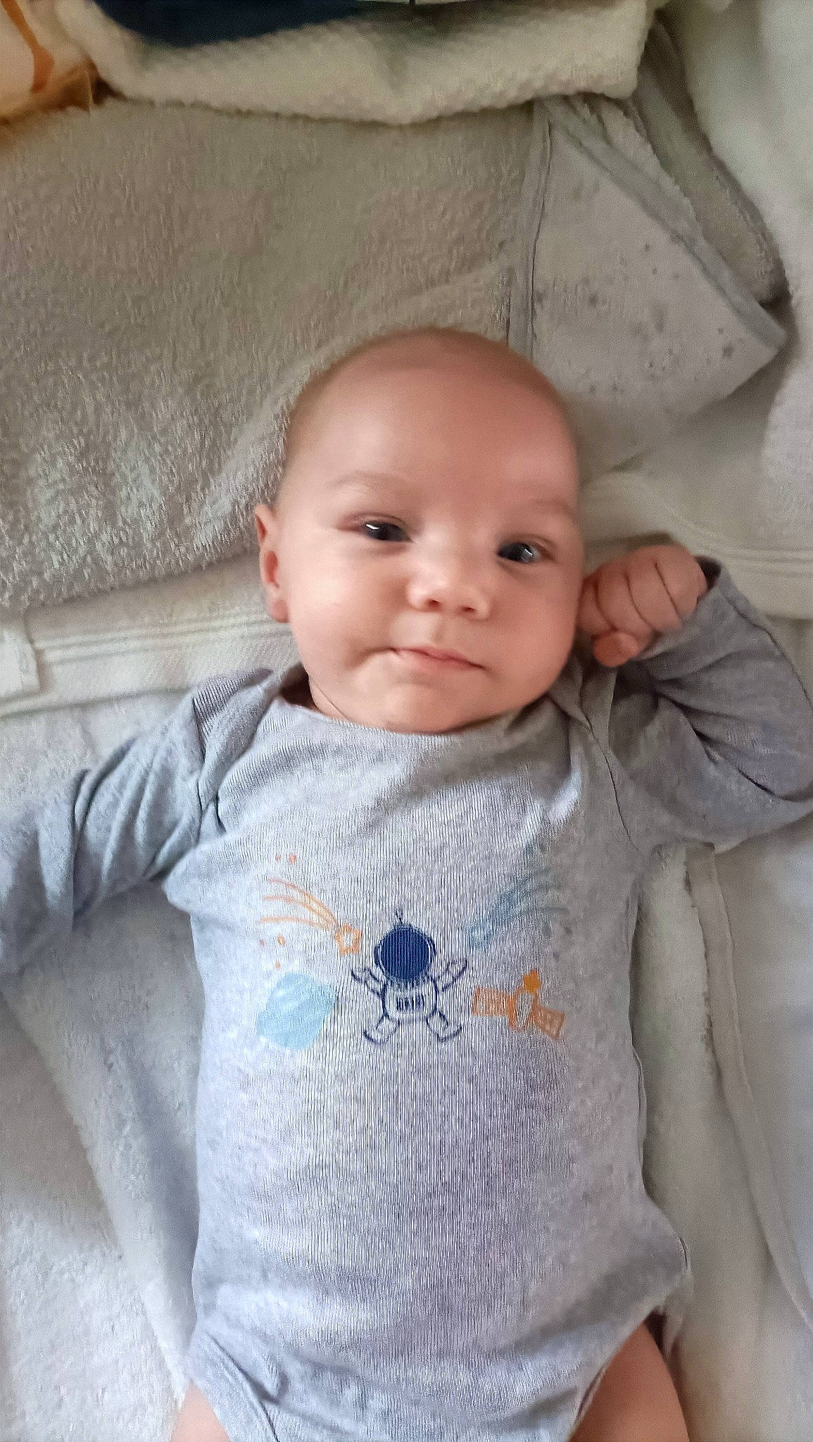 Logan participe au concours pour gagner de l'argent avec cette photo : baby, baby_toddler_clothing, cheek, child, chin, comfort, eye, eyebrow, face, grey, head, iris, lip, nose, outerwear, person, product, skin, sleeve, smile