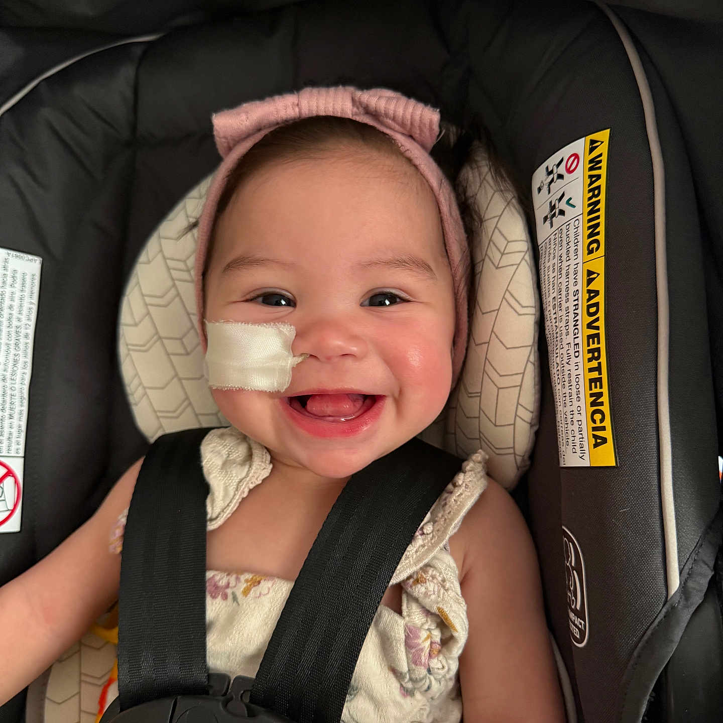 Sophia Wodrich is registered to the contest to win money with this photo: baby, child, smiling, headband, car_seat, seatbelt, medical_tape, cute, happy, infant, face, portrait, clothing, safety, indoor, closeup, person, seat, baby_girl, adorable