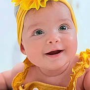 Brianna is registered to the contest to win money with this photo: baby, smiling, yellow_headband, flower, yellow_outfit, close_up, cute, infant, happy, child, portrait, face, skin, eyes, hand, clothing, headwear, baby_girl, adorable, cheerful