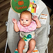 Arizona Rose joined the competition — help win amazing prizes! baby, infant, child, portrait, smiling, sitting, bouncer, baby_chair, pink_shirt, diaper_cover, turtle_pattern, halloween, pumpkin, colorful_blanket, wooden_floor, indoor, baby_toys, happy, face, arms