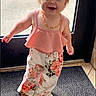 Lillian joined the competition — help win amazing prizes! toddler, child, girl, standing, smiling, indoor, doorway, pink_top, floral_pants, footwear, light, daylight, happy, curious, person, young_child, small_pony_tail, floor_mat, casual_clothing, portrait
