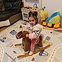 Azra joined the competition — help win amazing prizes! carpet, child, colorful, cute, floor, furniture, indoor, living_room, pigtails, pink_pajamas, play_kitchen, playroom, plush_toy, rocking_horse, smiling, sofa, toddler, toy, white_socks, wooden_toy