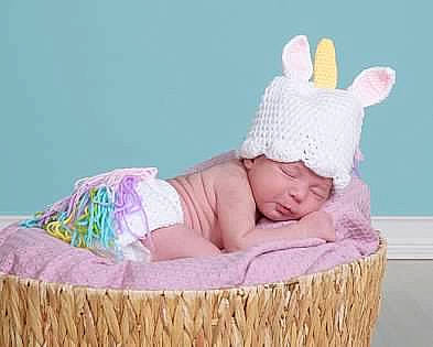 Eliyana is registered to the contest to win money with this photo: baby, baby_products, baby_toddler_clothing, cap, child, comfort, costume_hat, event, fashion_accessory, happy, headgear, headwear, knit_cap, linens, magenta, person, pink, sitting, toddler, wood