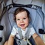 toddler, child, smiling, blue_eyes, hair, stroller, safety_harness, shirt, palm_tree_pattern, shorts, happy, cute, baby, seat, outdoor, sunlight, portrait, person, infant, casual_clothing