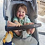 Arthur a rejoint le concours — aidez-le/la à gagner de superbes lots ! toddler, stroller, baby, smiling, child, toy, indoor, seat, happy, foot, hand, clothing, face, person, furniture, playful, baby_toy, grin, infant, cushion