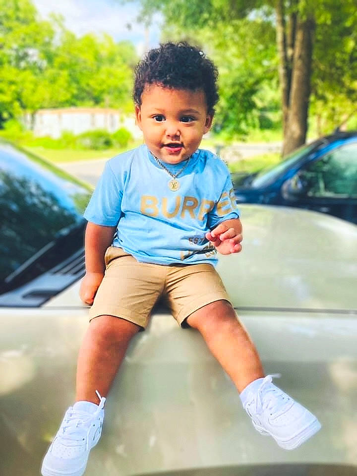 Kashton joined the competition — help win amazing prizes! automotive_design, automotive_exterior, car, cool, electric_blue, fun, grass, happy, head, hood, leg, leisure, person, recreation, shoulder, skin, t_shirt, tints_and_shades, toddler, tree