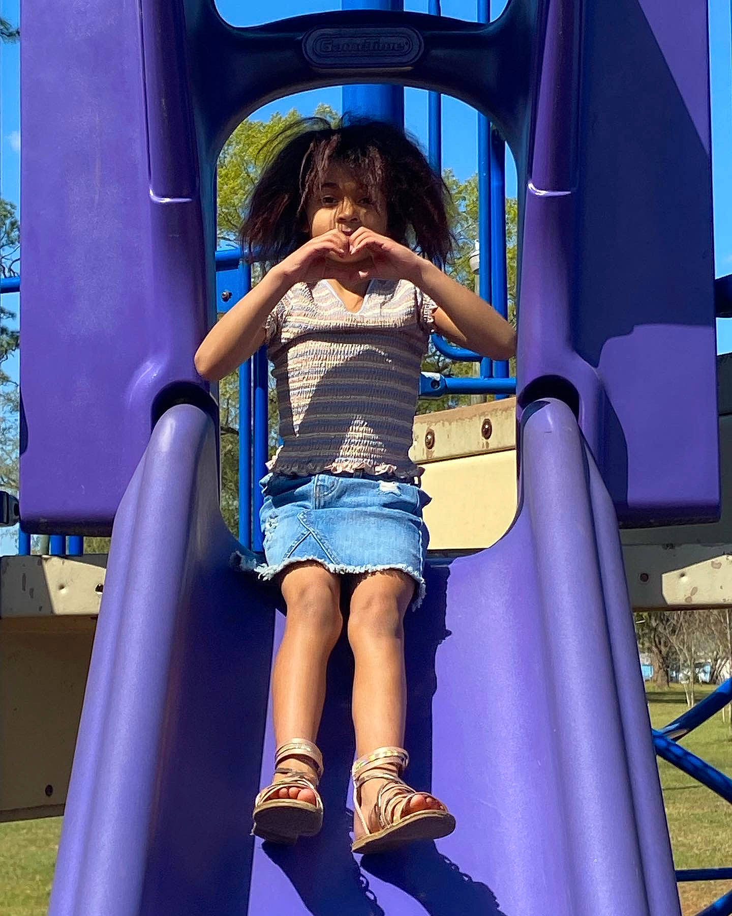 Myah is registered to the contest to win money with this photo: azure, blue, chute, city, electric_blue, fun, human_leg, human_settlement, leg, leisure, outdoor_play_equipment, person, play, playground, playground_slide, purple, recreation, shorts, thigh, toddler