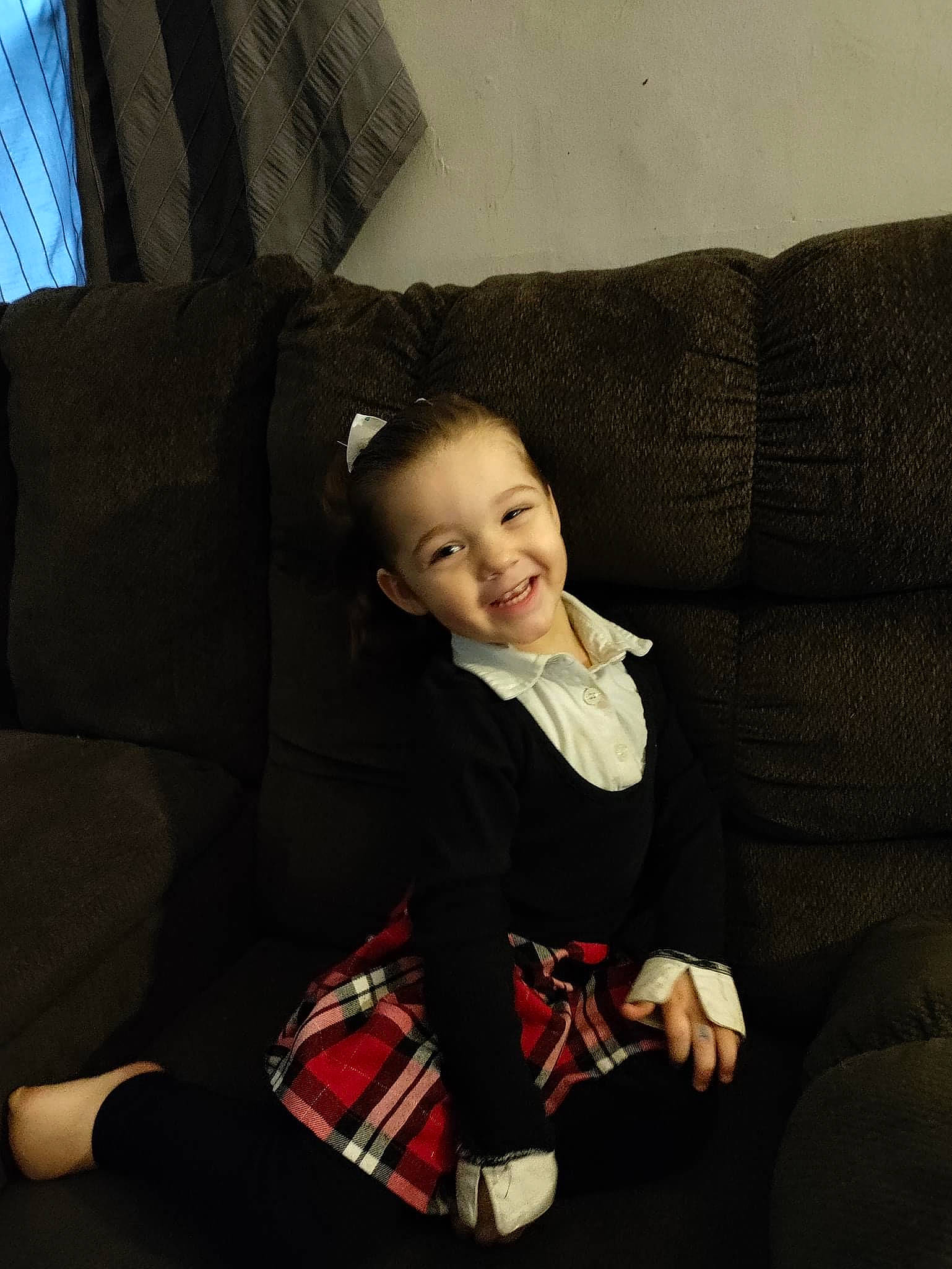 Aria joined the competition — help win amazing prizes! collar, comfort, couch, flash_photography, formal_wear, furniture, head, human_leg, joy, knee, lap, leg, person, plaid, sitting, sleeve, smile, sock, tartan, textile