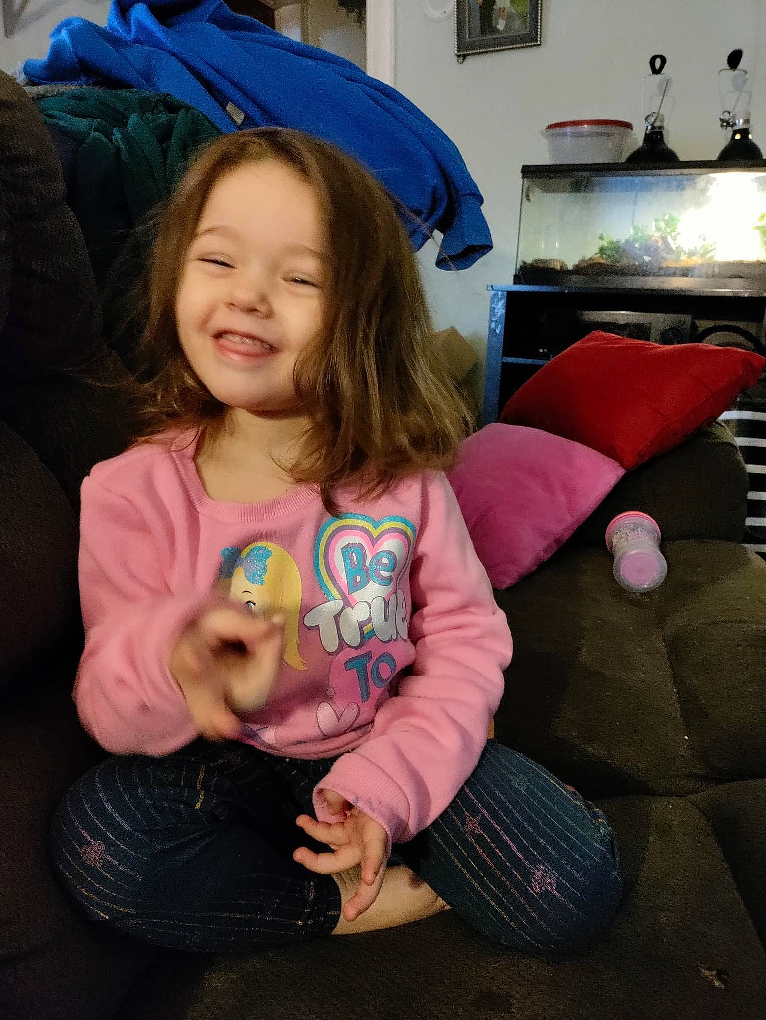 Aria is registered to the contest to win money with this photo: beauty, child, comfort, event, floor, flooring, fun, happy, iris, joy, lap, long_hair, mouth, person, pink, shoulder, skin, smile, t_shirt, textile