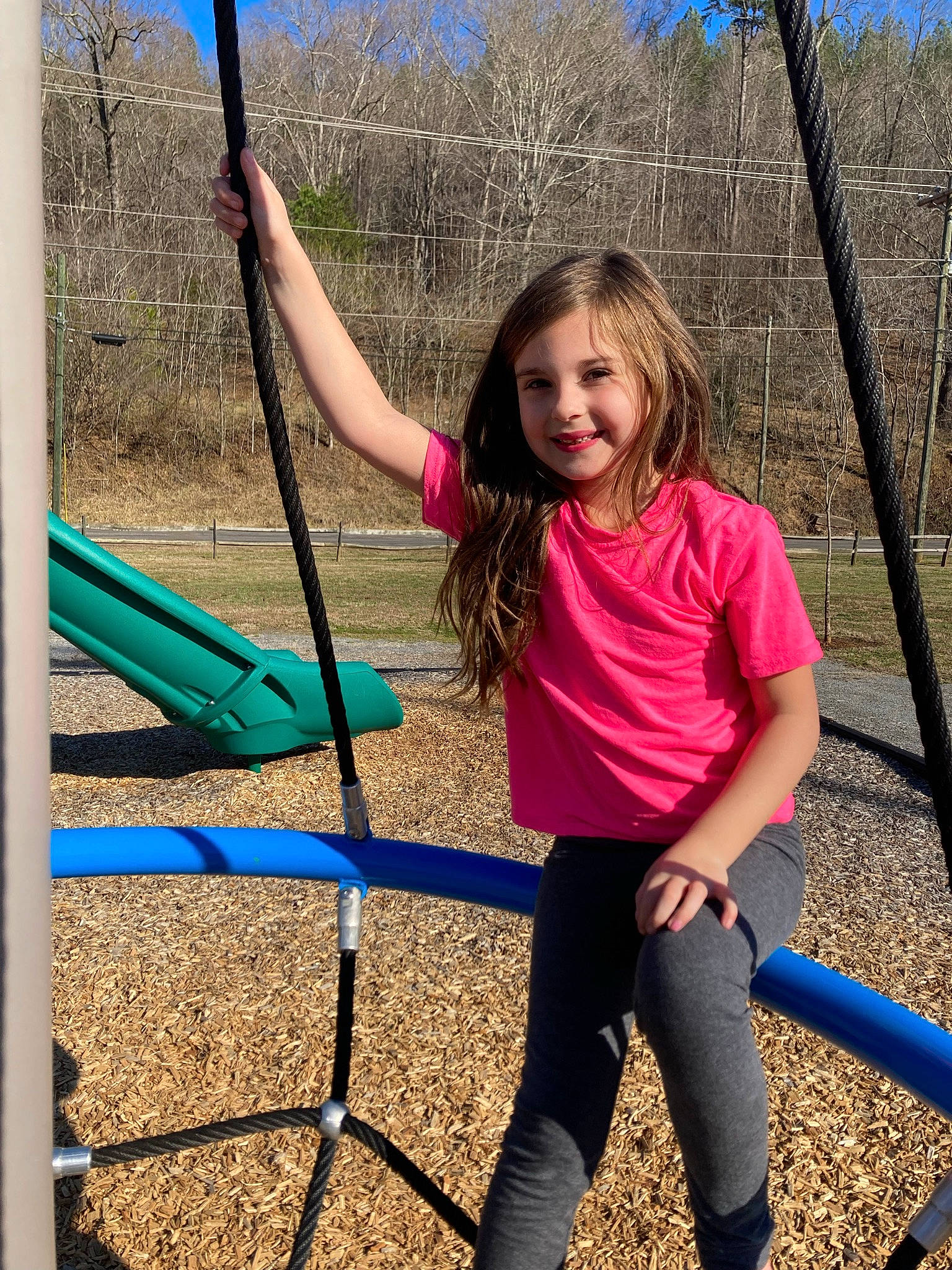 Kaelynn is registered to the contest to win money with this photo: city, clothing, electric_blue, facial_expression, fun, grass, happy, human_settlement, joy, leisure, outdoor_play_equipment, people_in_nature, person, playground, public_space, recreation, sky, sleeve, smile, standing