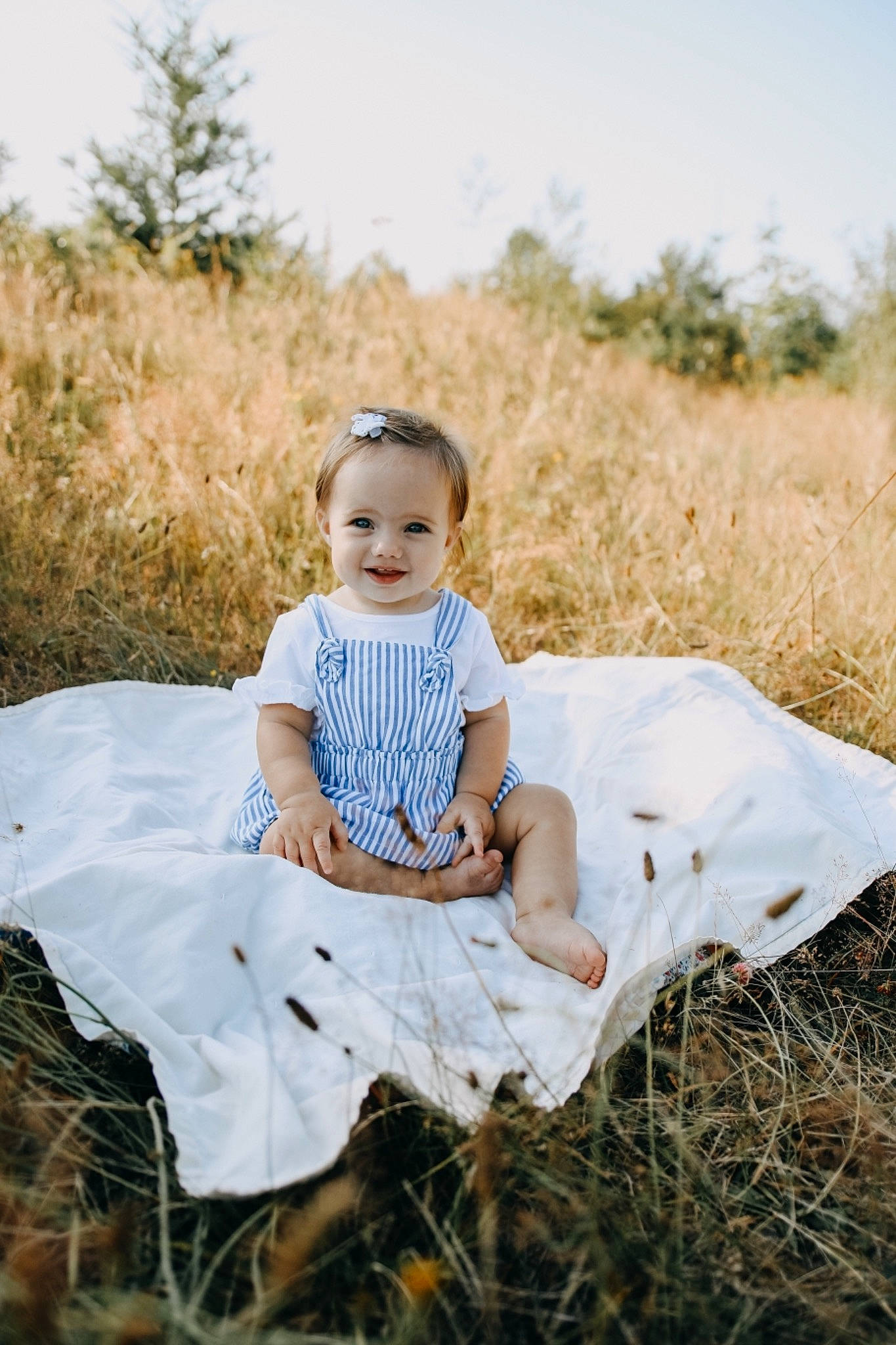 Marley Jo is registered to the contest to win money with this photo: baby, child, dress, grass, grass_family, grassland, joy, leaf, people, people_in_nature, person, photo_shoot, photograph, photography, portrait, portrait_photography, prairie, sitting, skin, smile