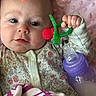 baby, infant, face, hand, toy, bottle, blanket, clothing, onesie, pink, purple, green, red, closeup, portrait, child, cute, indoor, soft, sleepwear