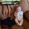 Ivey is registered to the contest to win money with this photo: baby, infant, smile, onesie, couch, blanket, clothing, soft, happy, indoor, person, child, seated, cute, cozy, face, expression, furniture, relax, home