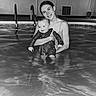baby, black_and_white, child, face, family, fun, happy, holding, indoor, joy, person, pool, portrait, reflection, relaxation, smile, swimsuit, together, water, woman